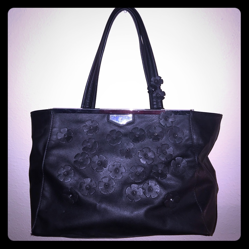 Black purse with small flowers on the front
